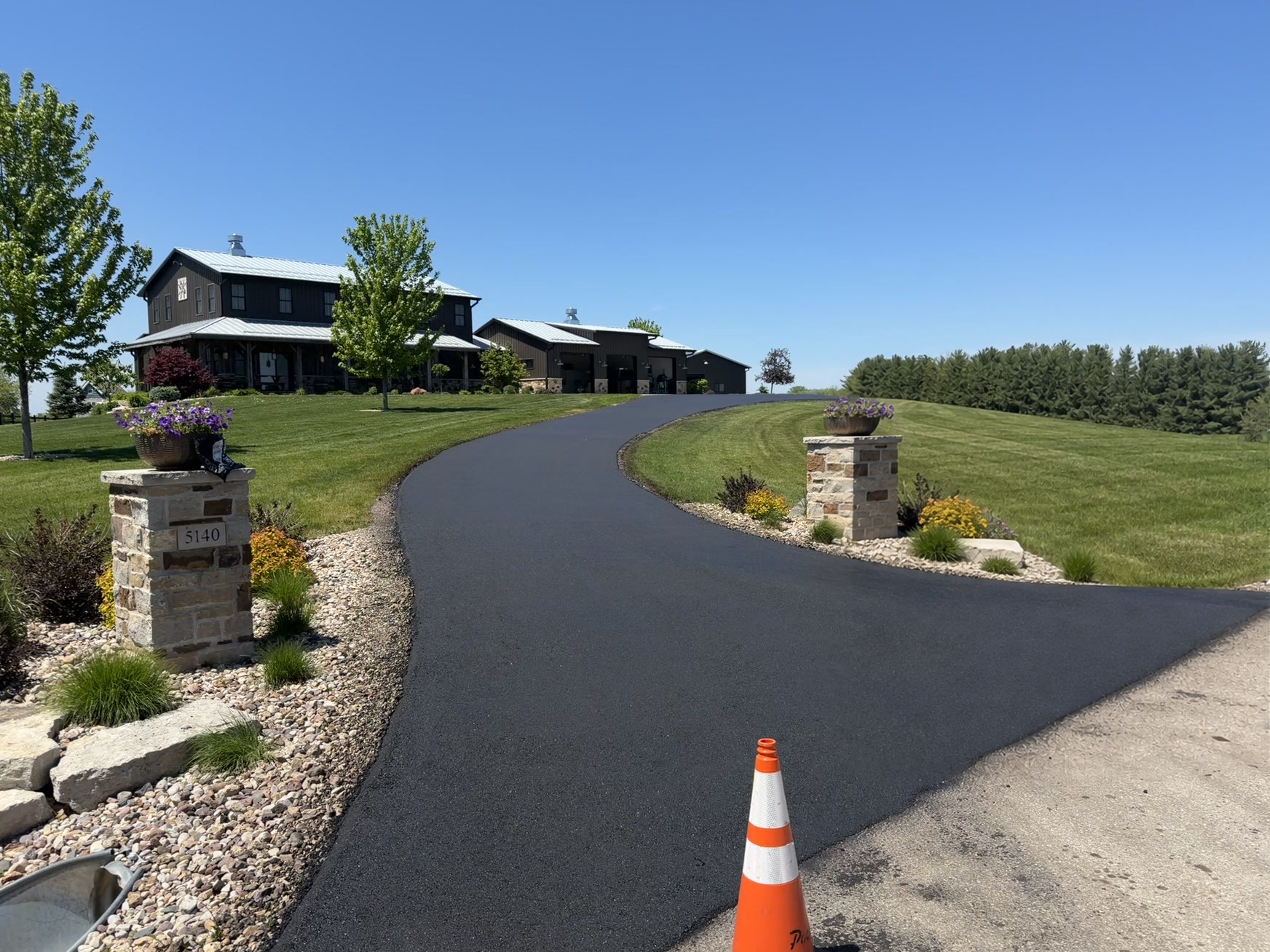 Asphalt paving machine laying fresh asphalt on a driveway